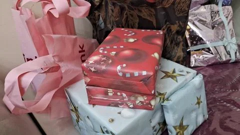 Festive red christmas gift boxes stacked on top of presents Stock Photos