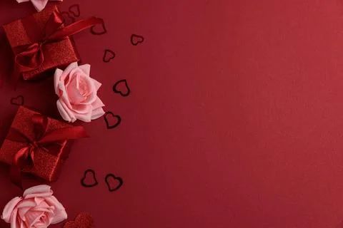 Festive Red Gift Boxes with Roses and Heart Confetti on Red Festive Backgro.. Stock Photos