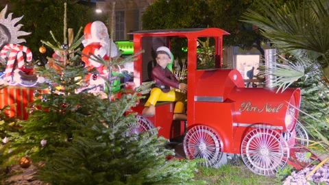 Festive Red "Pere Noel" Train Display Among Pine Trees With A Driver And Santa Stock Footage 327796805