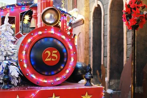 Festive red train engine adorned with colorful lights and holiday decorations Stock Photos