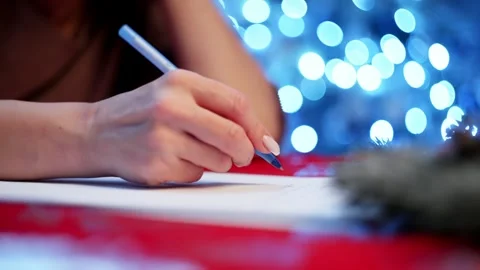 In the festive room, a woman writes down her dreams. Stock Footage 258582853