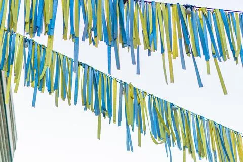 Festive scene with multiple blue and yellow decorative ribbons forming a patt Stock Photos