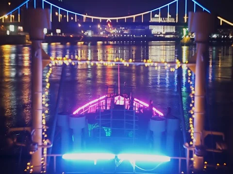 Festive ship nearing the bright bridge glowing at night Stock-Footage 71863536