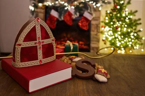 Festive Sinterklaas Setting. A Sinterklaas hat, book, and gifts create a cozy Stock Photos