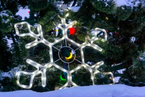 Festive snowflake on background of snowy branches of Christmas tree Stock-Fotos