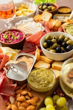 This festive spread features an array of cheese, cured meats, hummus, nuts, a Stock Photos