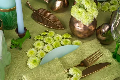 Festive spring table setting with flowers in green tone Stock Photos