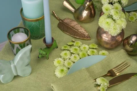 Festive spring table setting with flowers in green tone Stock Photos