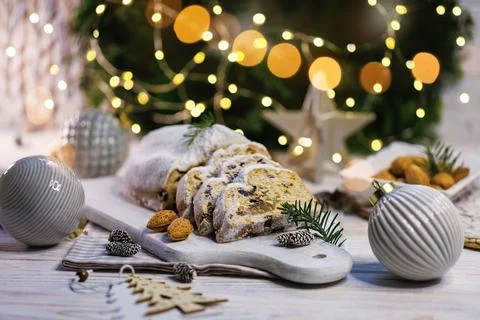 Festive stollen bread with almonds and evergreen branches Stock Photos
