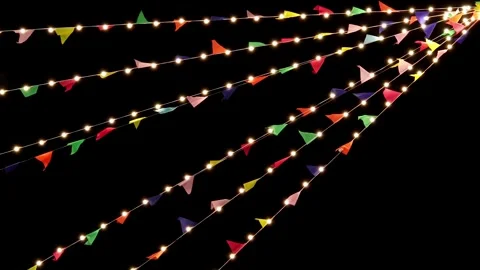 Festive string lights and colorful triangular flags hanging against night sky Stock Footage 322001549