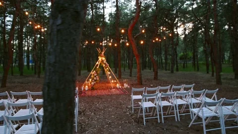 Festive string lights illumination on boho tipi arch decor on outdoor wedding Stock Footage 157652013