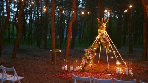 Festive string lights illumination on boho tipi arch decor on outdoor wedding Stock Footage 157652158