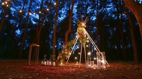 Festive string lights illumination on boho tipi arch decor on outdoor wedding Stock Footage 157652238