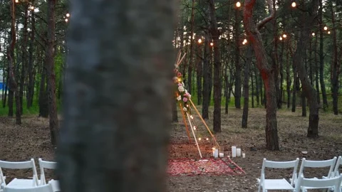 Festive string lights illumination on boho tipi arch decor on outdoor wedding Stock Footage 158164846