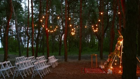 Festive string lights illumination on boho tipi arch decor on outdoor wedding Stock Footage 166954725