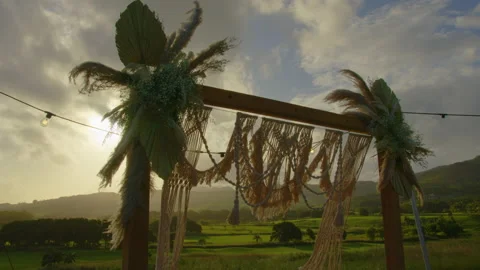 Festive string lights illumination on boho tipi arch decor on outdoor wedding Stock Footage 195625671