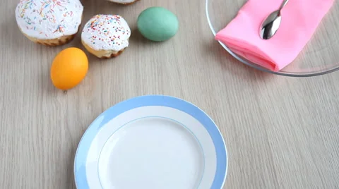 On the festive table alongside with painted eggs appears dish and Easter cake. Stock Footage 61730123