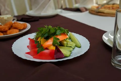 Festive table with appetizers. Vegetable plate of cucumbers, bell peppers Stock Photos