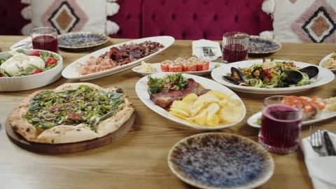 Festive Table with Assorted Dishes and Drinks Stock Footage 301531923