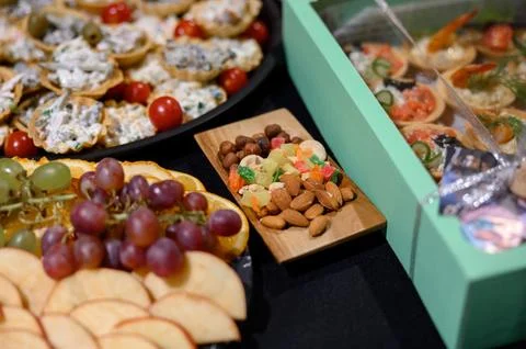Festive table with assorted snacks, canapes, fruits, nuts and dried fruits Stock Photos