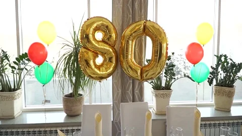 Festive table with balloons for the 80th anniversary Stock Footage 270123558