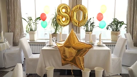Festive table with balloons for the 80th anniversary Stock Footage 270124236