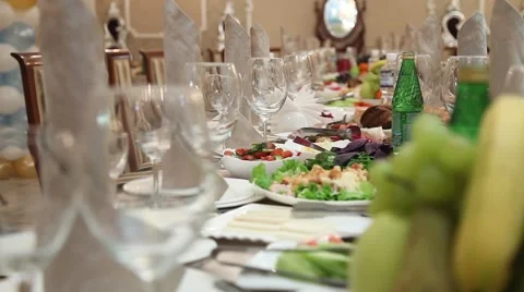 Festive table covered with. Plates and bottles food drinks. And a variety of dis Stock Footage 49446772