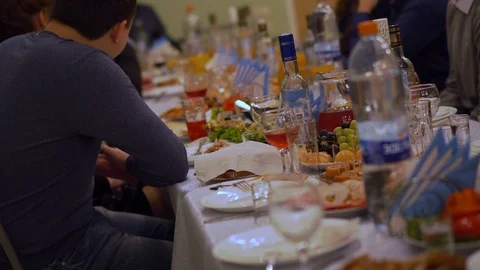 The festive table is covered with various snacks. Video stock 100347274