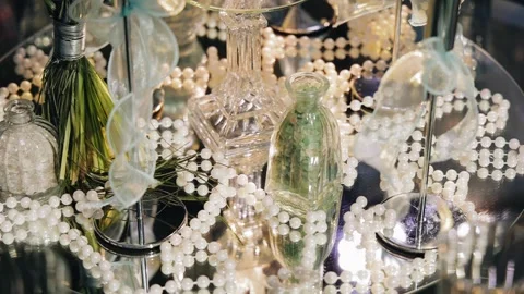 The festive table is decorated with beads, a mirror stand and other decor Stock Footage 336659585
