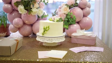The festive table is decorated with gel balls, gift boxes and a cake Stock Footage 236016696