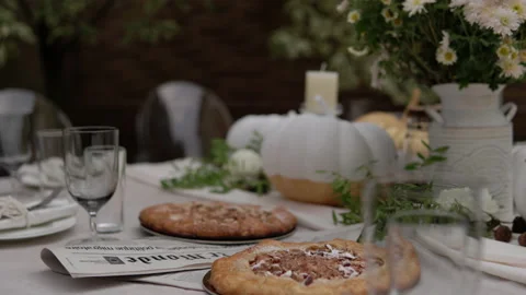 The festive table is decorated with pumpkins, flowers and herbs. Halloween party 스톡 동영상 141965812