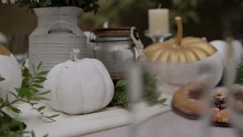 The festive table is decorated with pumpkins, flowers and herbs. Halloween party Видео 141970834