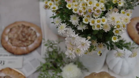 The festive table is decorated with pumpkins, flowers and herbs. Halloween party 스톡 동영상 141989036