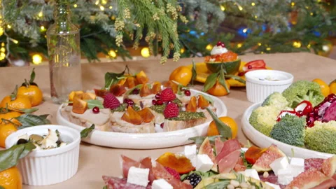 Festive table with delicious appetizers with cheese, prosciutto and berries Stock Footage 145210276