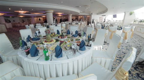 Festive table elegantly served in a luxurious restaurant. Flycam, circular pan Stock Footage 49770269