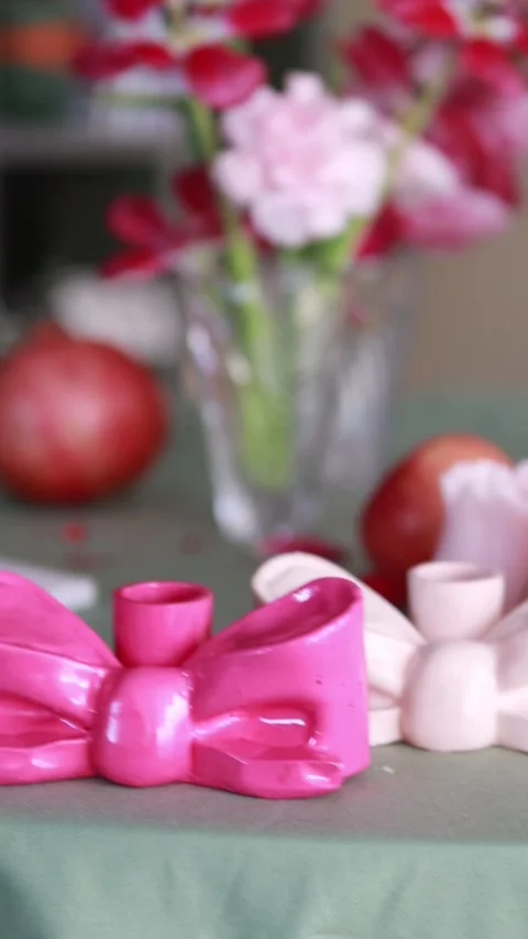 A festive table featuring candles in elegant bow-shaped holders 스톡 동영상 313483161