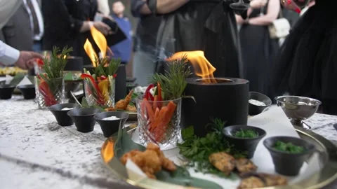 Festive table with fire, appetizers and salads on the table in the restaurant Video stock 277060805