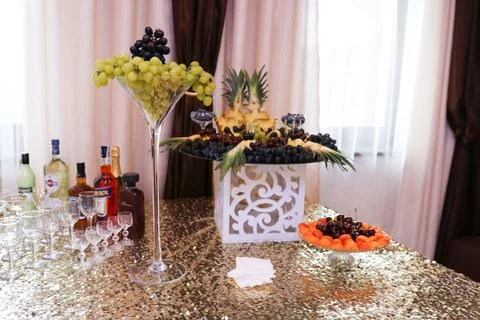 Festive table with fruit, Martini, Aperol, Jack Daniel's, Diplomat and glasse Stock Photos