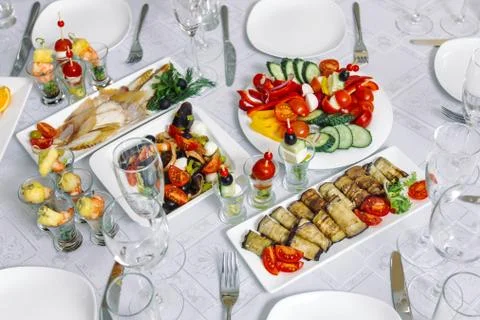 Festive table, on it are placed kanape, rolls from aubergines and zucchini. 스톡 사진