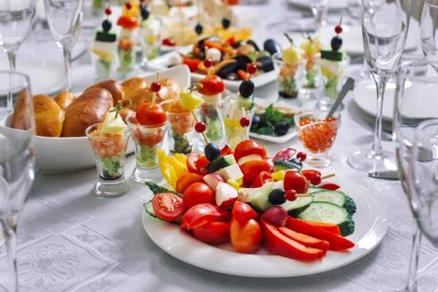 Festive table, on it are placed kanape, rolls from aubergines and zucchini. Photos