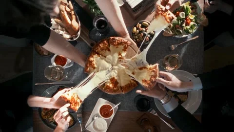Festive table with many delicious dishes with a large cheese pizza Stock Footage 314577391