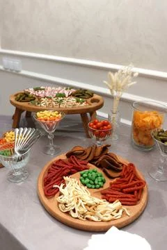 Festive table with meat appetizers, cheese, sausages and pickles arranged on  Stock Photos