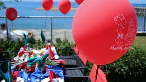 Festive table with red balloons with birthday on the beach Video stock 194683323