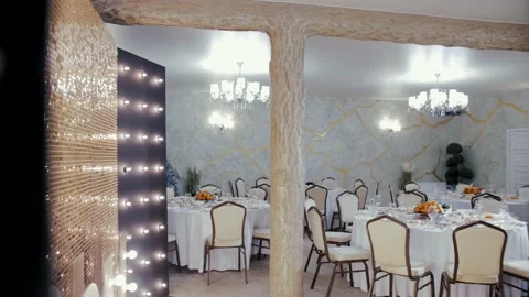Festive table in a restaurant against backdrop of beautiful light illumination Stock Footage 231808665