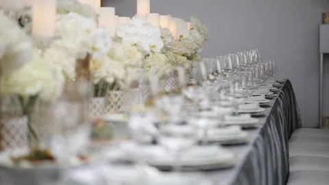 A festive table served by beautiful dishes in white colors surrounded by candles Stock Footage 122525262