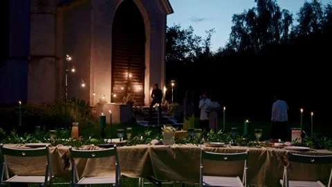 A festive table is served outdoors at night - Guests. Stock Footage 318928442