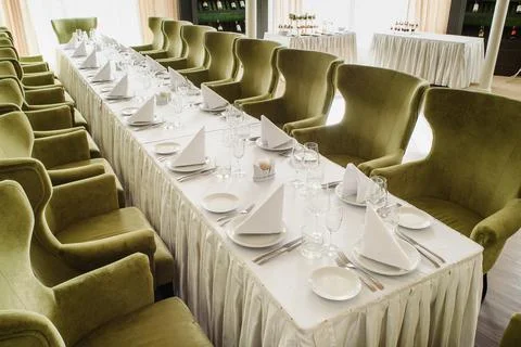 Festive table serving in a restaurant. Classic white set of wedding dinner table Stock Photos