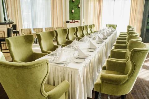 Festive table serving in a restaurant. Classic white set of wedding dinner table Stock Photos