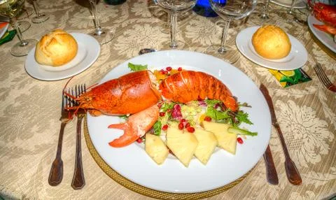 Festive table set with dish of huge grilled lobster and vegetable Stock Photos