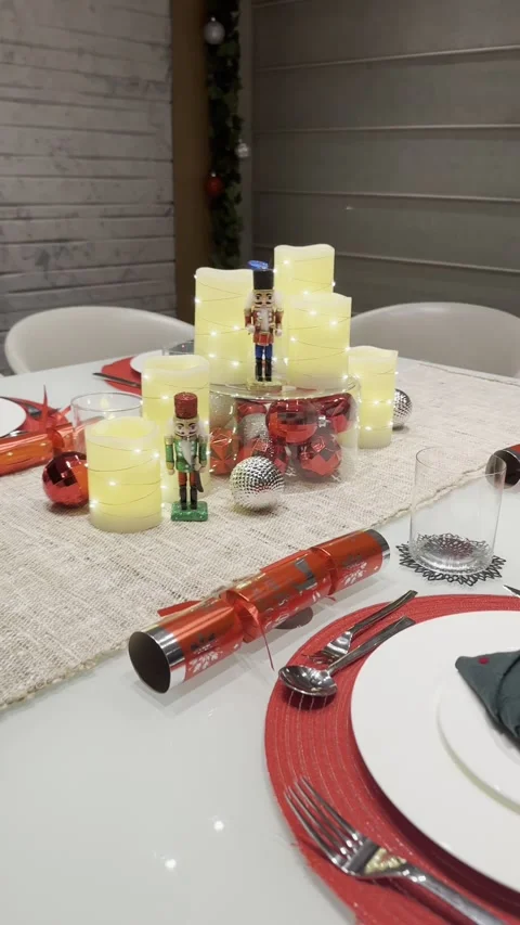 Festive table setting with candles and holiday decor nutcracker ornament Stock Footage 320499847